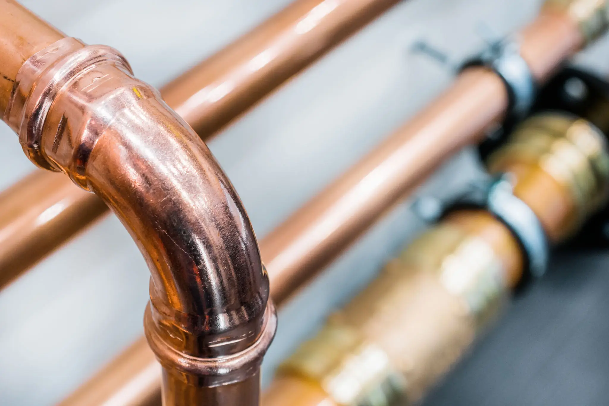 Close-up of copper plumbing pipes with precision bends.