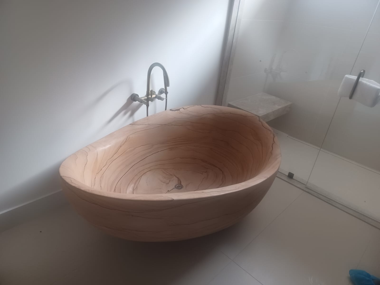 Elegant wooden bathtub with smooth curves in a modern bathroom.